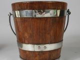 an image of a wooden bucket with metal handles on a white surface
