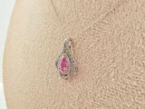 an image of a necklace with a pink stone on a mannequin torso