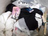 a pile of clothes in a plastic bag on the floor