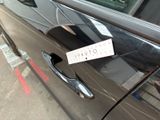 a sticker on the door handle of a car