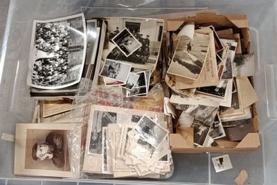 a plastic container filled with old photos and other items