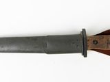 an old knife with a wooden handle on a white surface