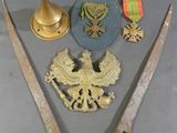 two swords, a hat, and a medal are on a table