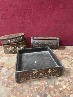 three wooden boxes sitting on a table with a red wall in the background