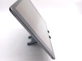 a tablet computer sitting on a stand on a white surface