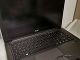an open laptop computer sitting on top of a table next to a charger