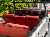 a truck with luggage in the back of it on the road