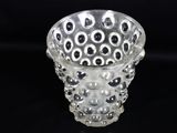 a clear glass vase with black and white dots on it