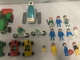 a lot of toy vehicles and people on the bed