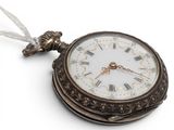 a small pocket watch with roman numerals on it