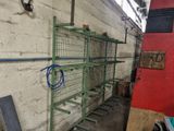 a green shelf with a bunch of wires on it