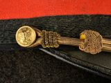 an image of a close up of a hat with a gold clasp