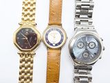 three different types of watches are displayed on a white surface