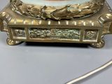 a gold plate with a bowl on top of it