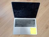 a laptop computer sitting on a table with a sticky note attached to it