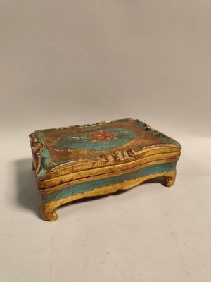an old wooden box sitting on top of a white surface