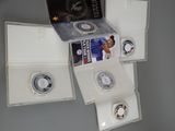 a box of silver coins with a picture of a basketball player on it