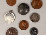 several different coins are arranged in a circle on a white surface