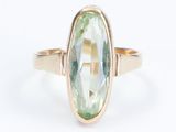 a picture of a ring with a green stone in it