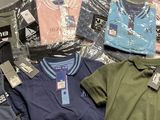 a lot of shirts that are sitting on a table