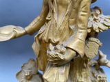 a statue of a woman holding a tray with flowers on it