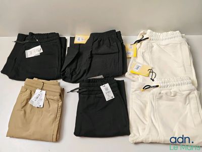 five pairs of men ' s pants are laid out on a table