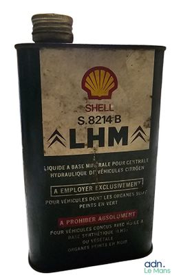 an old shell oil can is sitting on a white surface