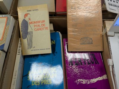 boxes of books are stacked on top of each other on a table