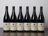 six bottles of wine are lined up on a table