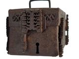 an old iron box with a keyhole on top of it