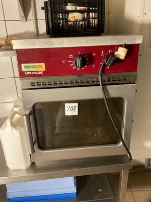 an image of a kitchen with a microwave and a basket of eggs