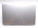a silver laptop computer sitting on a white surface