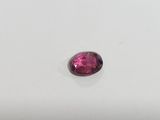a close up of a pink tourmaline stone on a white surface