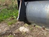 a close up of a large machine on a dirt field