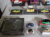 a lot of toy cars on display on a table