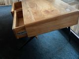 a table with a drawer on it in the middle of a room