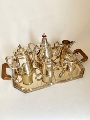 a silver tray with a silver tea set on it
