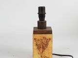 an image of a small bottle of perfume on a white surface