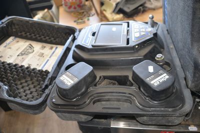 a black case with two batteries in it on a table