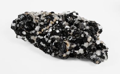 a close up of a piece of black and white rock on a white surface