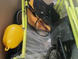a cardboard box filled with various items including a stroller and a bicycle