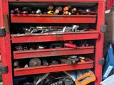 un établi rouge sur lequel sont posés des outils, dans un garage