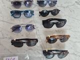 several pairs of sunglasses are on a table with a price tag