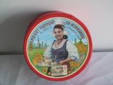 a red tin with a picture of a woman holding a plate