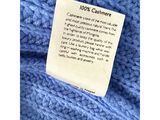 the label on a blue sweater reads 100 % cashmere