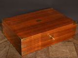 an old wooden box with brass hardware on a wooden floor