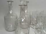 bottles and glasses are lined up on a white surface