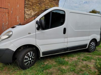 a small white van parked in front of a barn