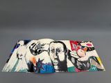 an open book with a painting on it sitting on top of a table