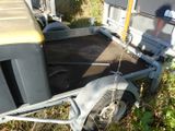 a trailer with a trailer attached to it in the grass